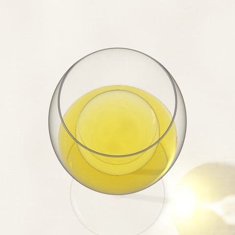 A glass of golden, mature white wine seen from above on a linen cloth