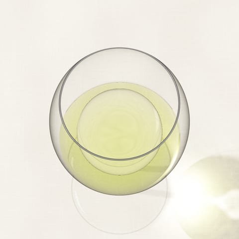 A glass of pale lemon-green Riesling, seen from above on a linen cloth