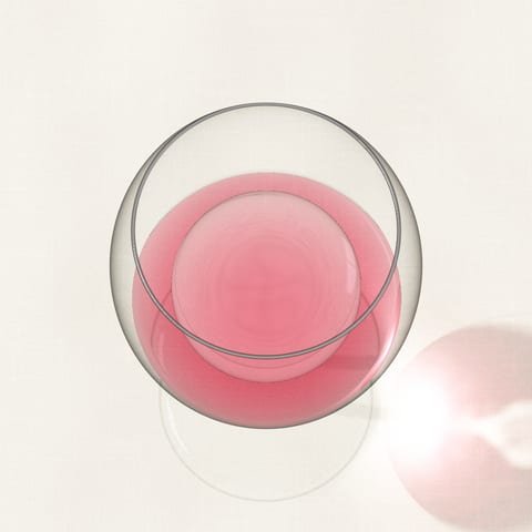 A glass of pale rosé wine seen from above on a linen cloth